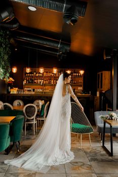 Bride in wedding dress and bridal veil in cafe. Advert for social networks for wedding agency and bridal salon.