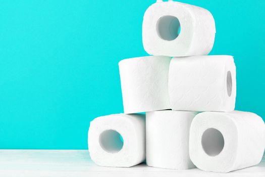 Toilet paper rolls on turquoise bright background