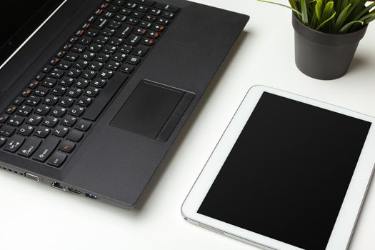 Open laptop with digital tablet on the table