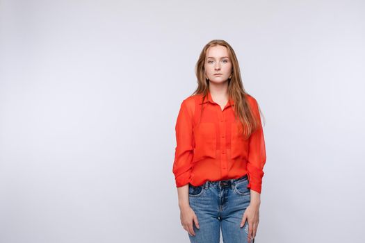 Upset young woman wearing red blouse and jeans