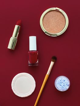Beauty, make-up and cosmetics flatlay design with copyspace, cosmetic products and makeup tools on burgundy background, girly and feminine style