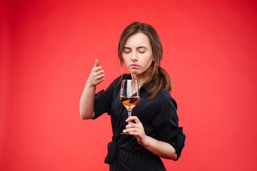 Woman with closed eyes smelling wineConcept of alcohol and scent.