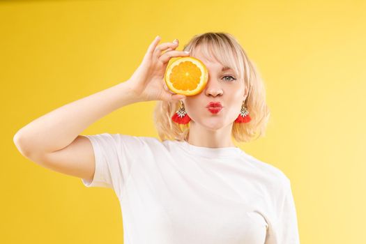 Woman with halved orange on her eye.