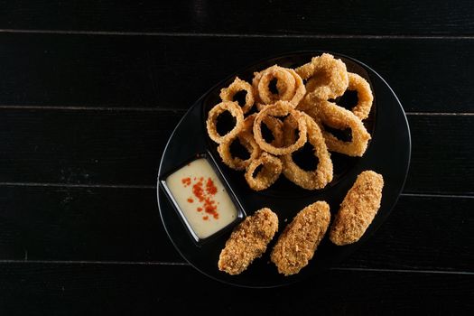 Beer snacks. Breaded meat appetizer and onion rings