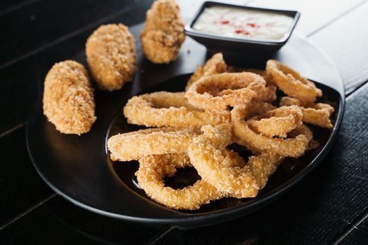 Beer snacks. Breaded meat appetizer and onion rings