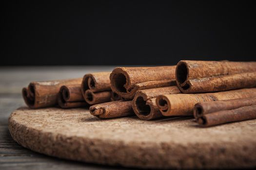 Cinnamon sticks on wooden background. creative photo