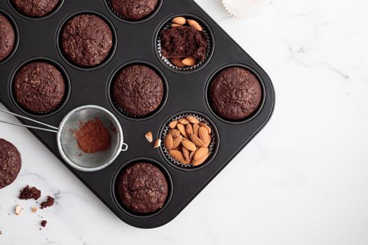 Freshly baked chocolate muffins in a baking pan