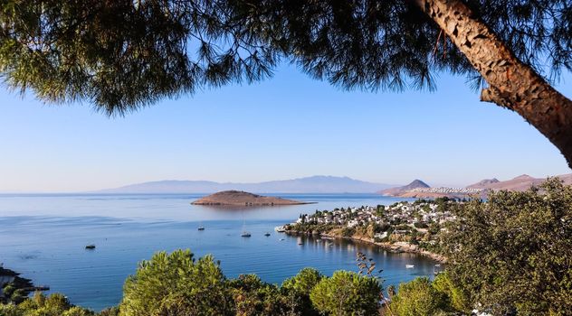 Aegean coast with marvelous blue water, rich nature, islands, mountains and small white houses