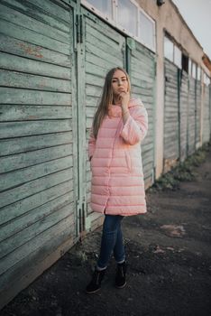 Young gorgeous blonde girl dressed fashion pink jacket and blue jeans