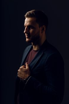 Business man portrait on dark background. Handsome young man weared suit in studio. Confident professional fashion male posing in studio