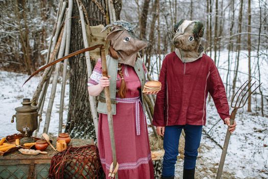 People in national costumes with animal heads celebrate the arrival of the pagan holiday Maslenitsa. An ancient pag
