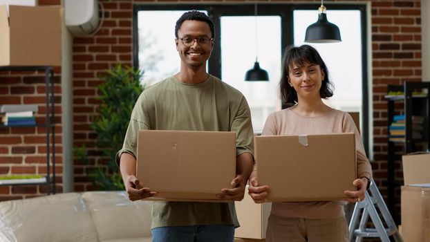 Portrait of cheerful people moving in rented apartment flat