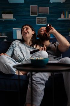 POV of cheerful man and woman laughing at comedy movie