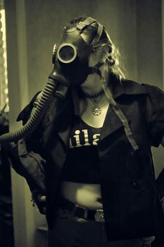 girl in a gas mask with a hose sepia