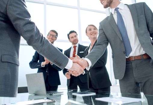 business handshake of business partners after signing the contract