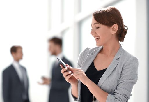 smiling businesswoman using her smartphone