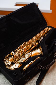 Saxophone musician instrument in case. Sax musical instrument for play jazz.