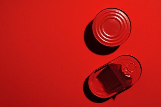 Dark red tin can on red background