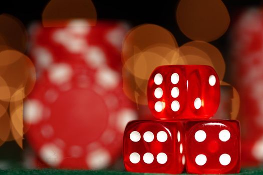 Three red dice against blurred bokeh background