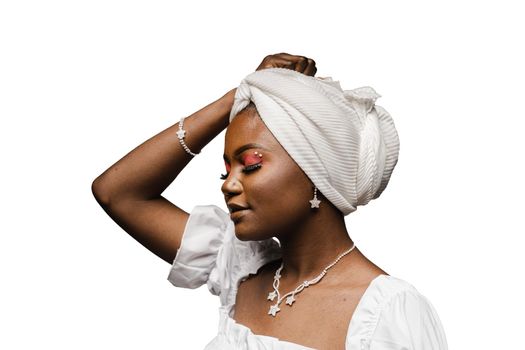Beauty portrait of black muslim woman weared white dress and headscarf on white background. Softness and wellness of body and skin.