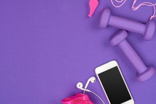 Fitness accessories on a color background.