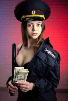 sexy woman in a Russian police uniform with a baton and money . English translation Police