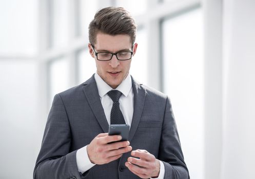 young businessman reading SMS on his smartphone