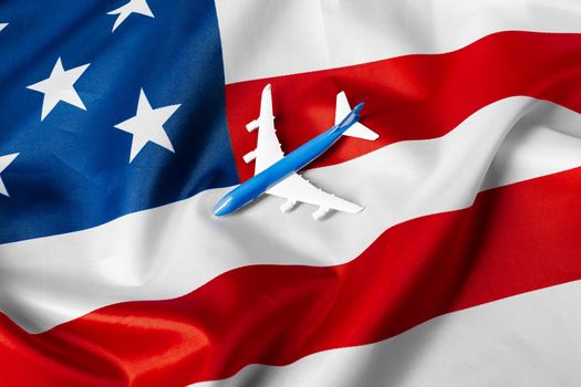 toy jet plane and flag of USA. creative photo.
