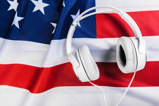 American national flag and white headphones close up