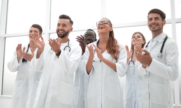 fellow doctors are applauding and smiling