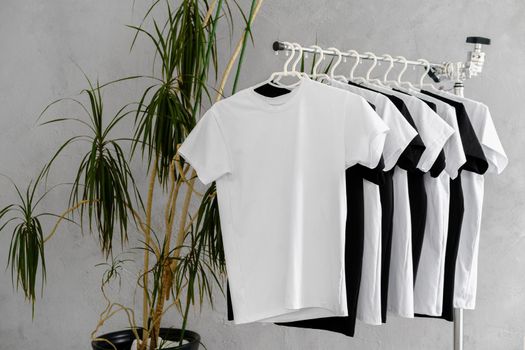 Row of black and white t-shirts hanging on rack