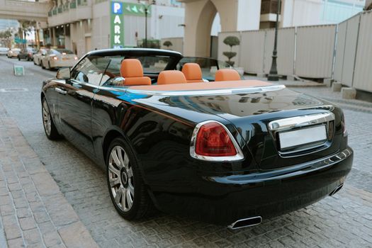 Close up of luxury cabriolet convertible car with orange leather interior
