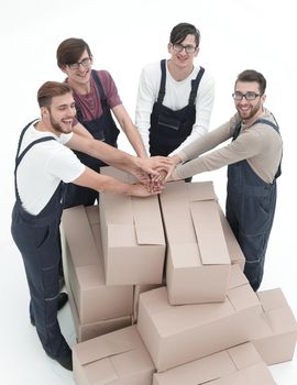 Cheerful movers leaning on stack of boxes isolated on white back