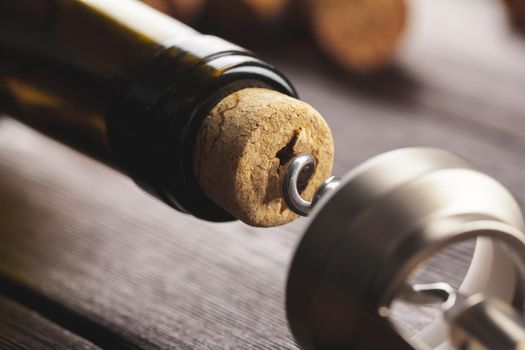 Opening wine bottle with a corkscrew close up