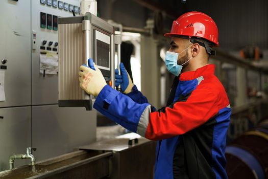 Portrait of a black male factory engineer wearing protective mask