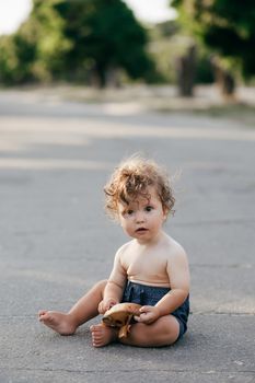 Closeup portrait of a little baby boy on wheat summer field. Parenthood concept.