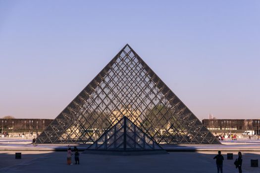 Louvre glass pyramid in Paris on a sunny day