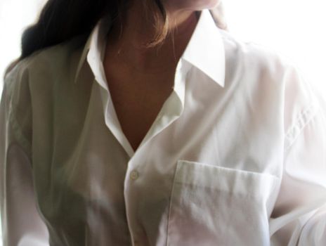 Beautiful girl with dark long hair in a white shirt