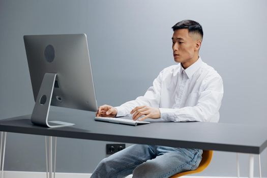 worker sit at a desk in front of a computer isolated background