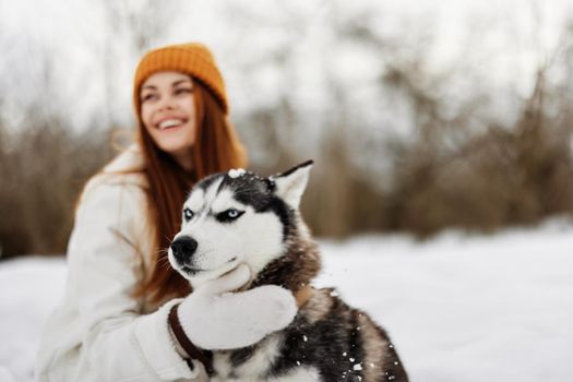 woman with dog on the snow walk play rest Lifestyle. High quality photo