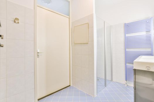 Bathroom interior with white and blue tiles