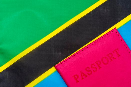 On the background of the flag of Tanzania is a passport.