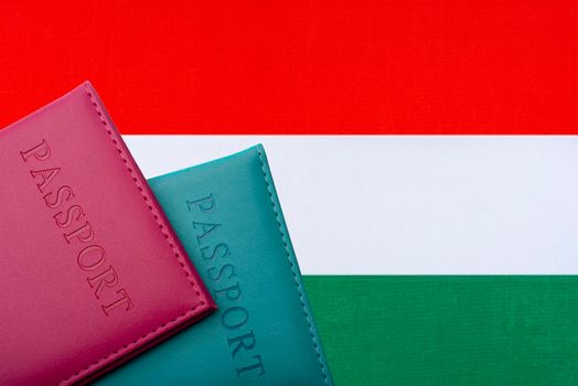 On the background of the flag of Hungary passports.