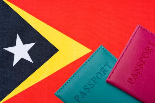 Against the flag of East Timor two passports.