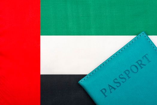 On the background of the flag of the UAE United Arab Emirates is a passport.