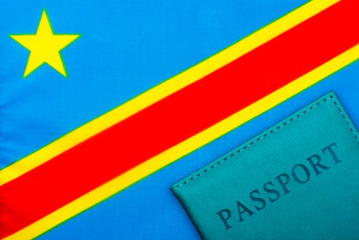 On the background of the flag of the Democratic Republic of the Congo is a passport.