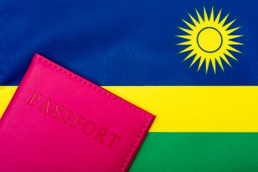 On the background of the flag of Rwanda is a passport.