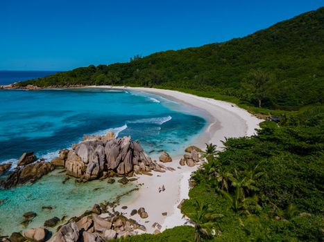 Anse Source d'Argent beach, La Digue Island, Seyshelles, Drone aerial view of La Digue Seychelles bird eye view.of tropical Island. mature couple men and women on vacation Seychelles