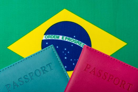 On the background of the Flag of Brazil lie a passport.
