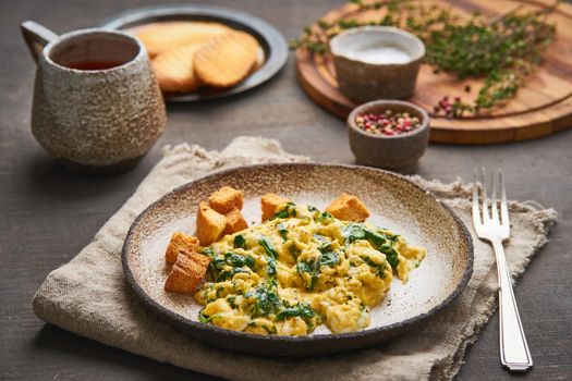 Scrambled eggs with spinach, cup of tea